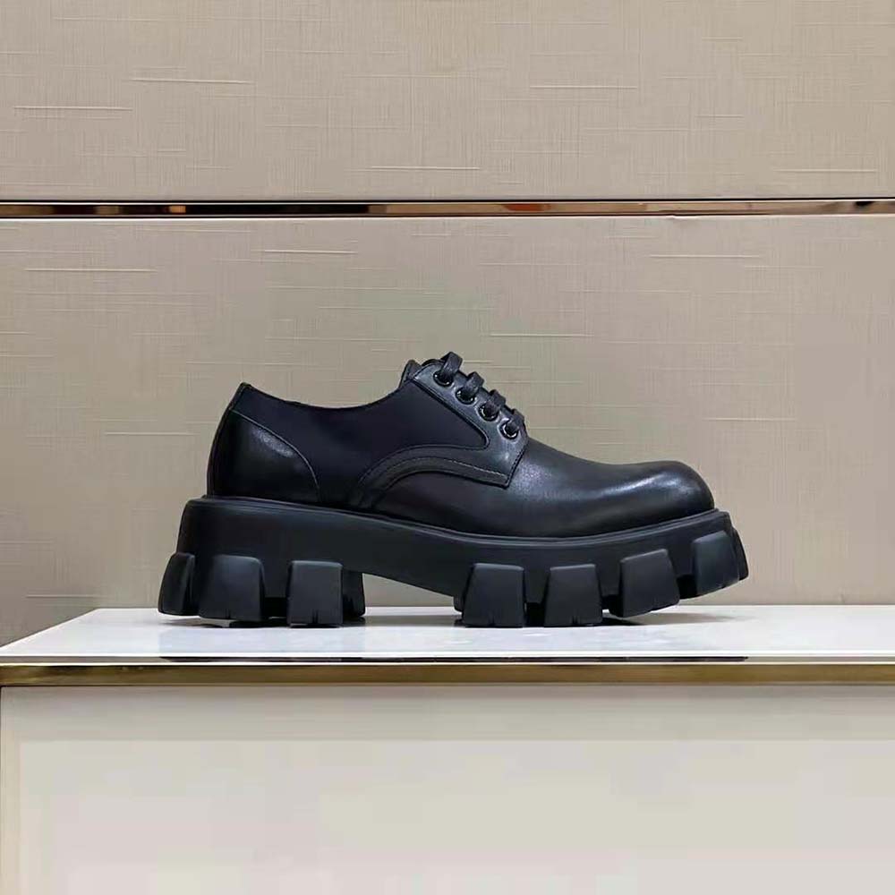 Close-up of black brushed Rois leather and lace-up detail on Prada shoes