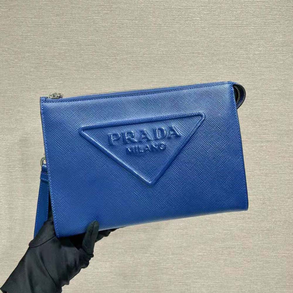 Close-up of silver Prada logo hardware on navy Saffiano leather pouch
