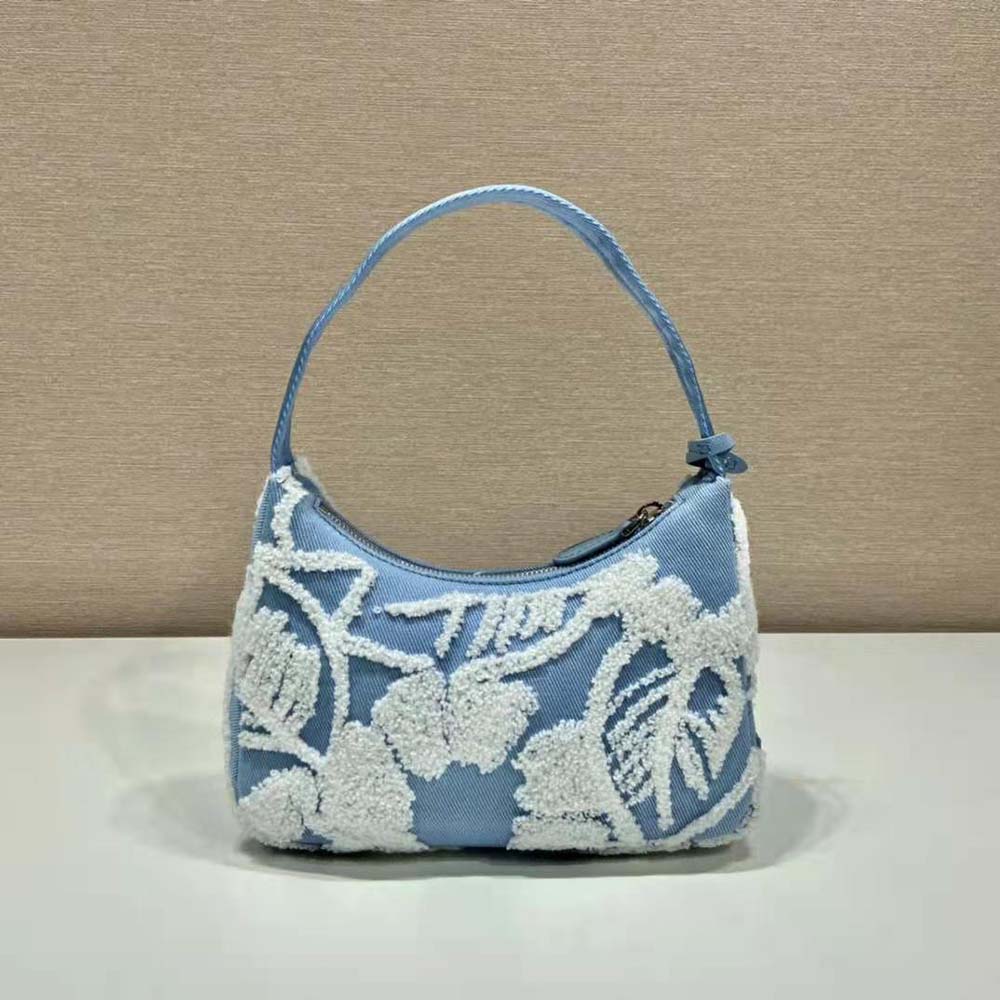 Side angle showing compact silhouette of Prada Women Re-Edition 2000 Embroidered Drill Mini Bag-Blue