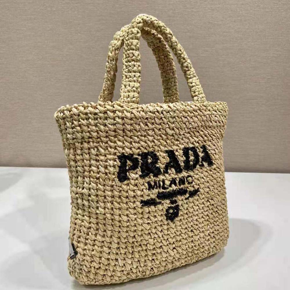 Side angle showing compact silhouette of Prada Women Small Raffia Tote Bag-Natural