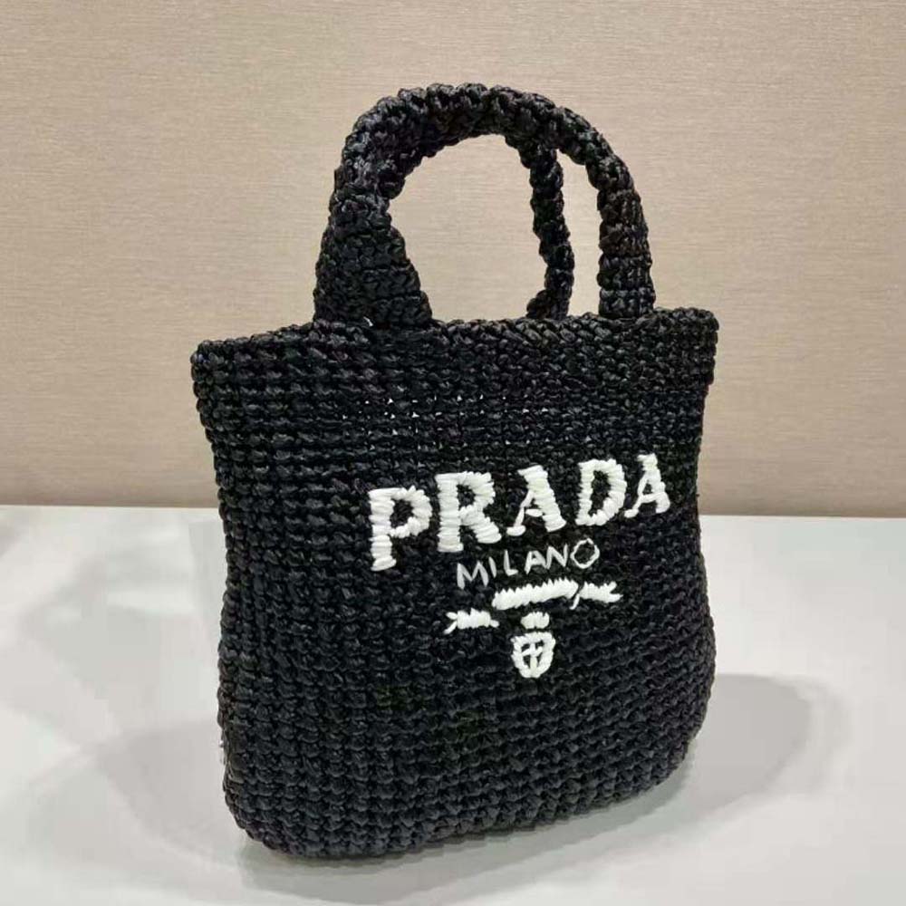 Side angle of Prada Women Small Raffia Tote Bag-Black highlighting leather trim