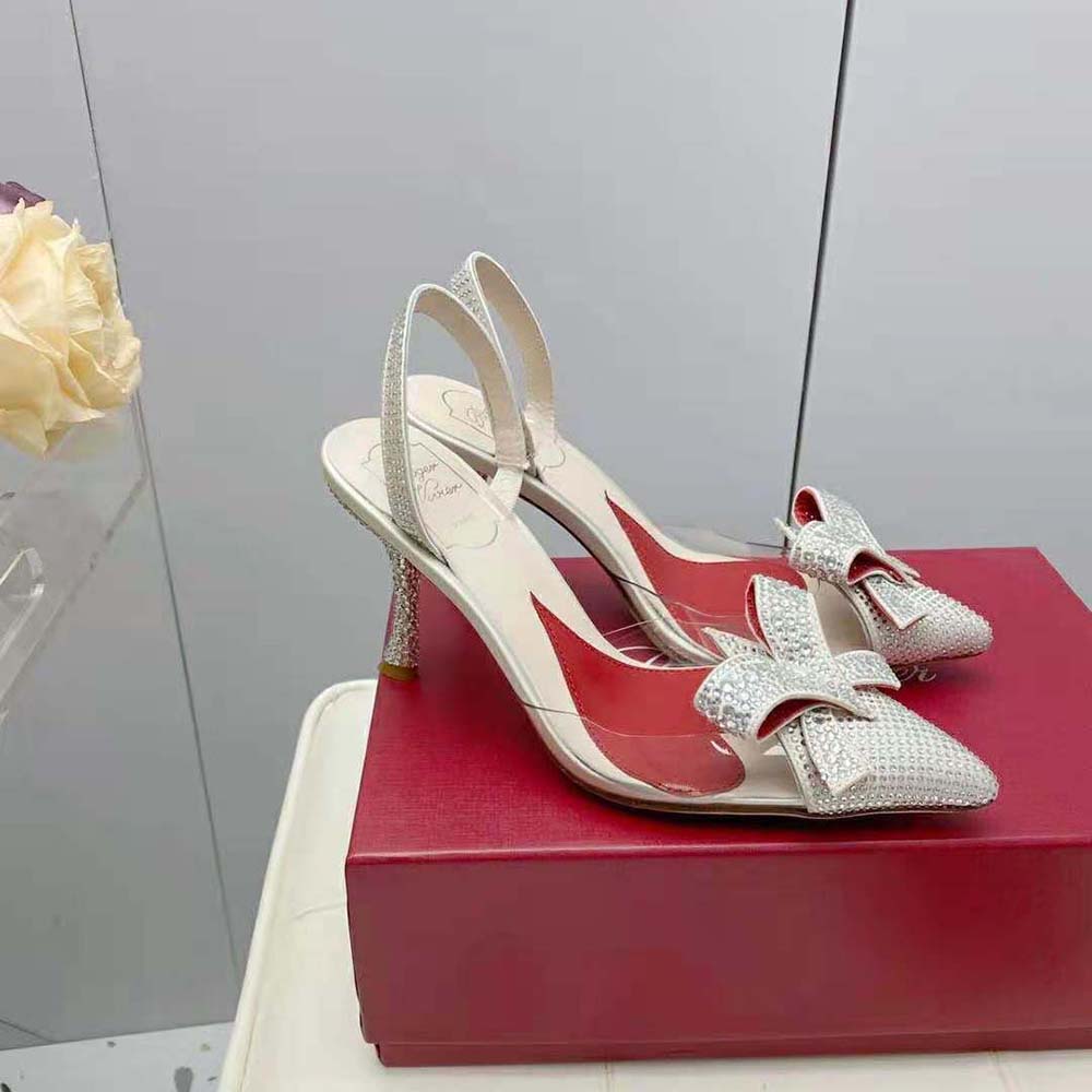 Top angle showing transparent PVC and silver bow on Roger Vivier pumps