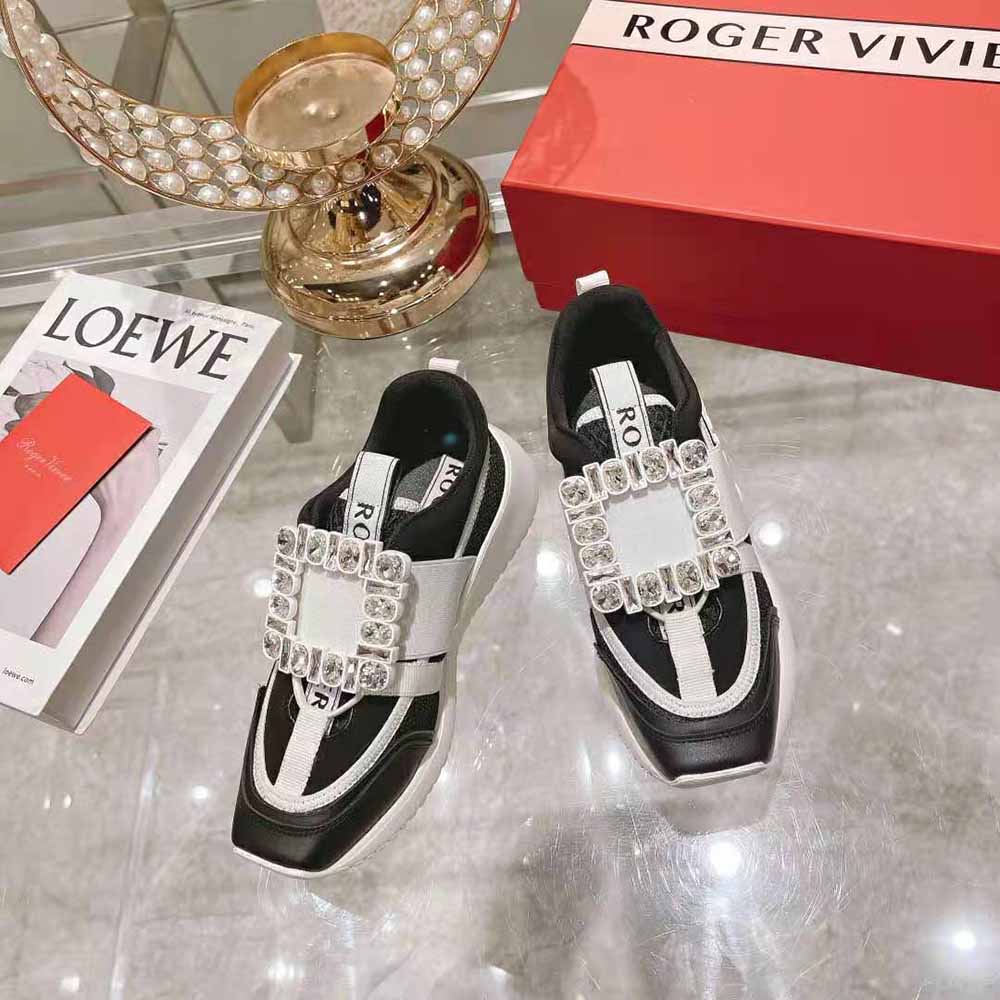 Close-up of rhinestone buckle detail on Roger Vivier black sneakers