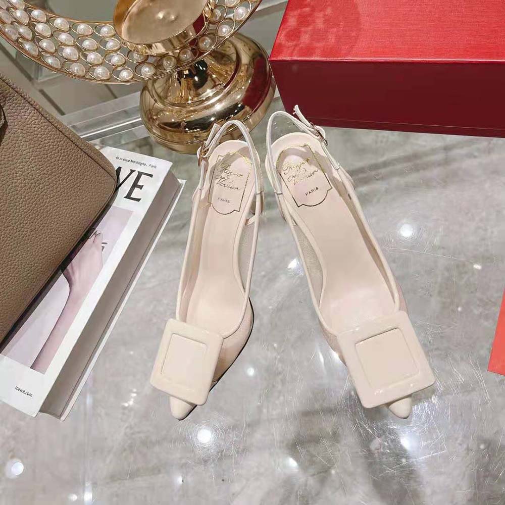 Close-up of polished metal buckle on Roger Vivier Viv’ In The City white slingback pumps