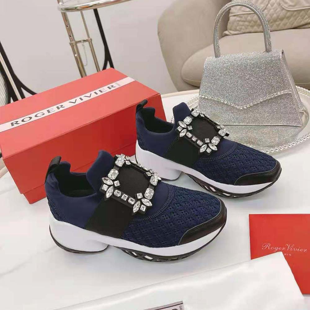 Top angle showing lace-up and technical fabric detail on navy sneakers
