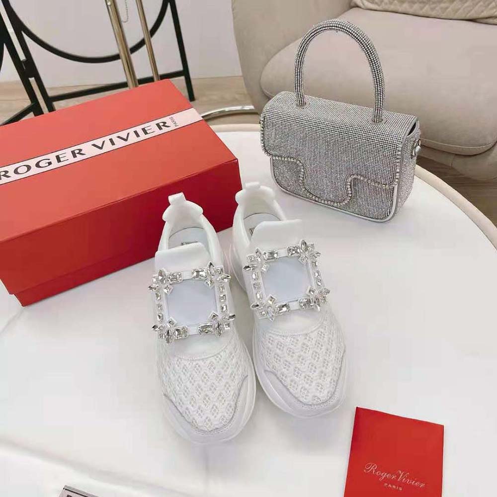 Close-up on crystal Viv’ buckle of Roger Vivier white sneakers