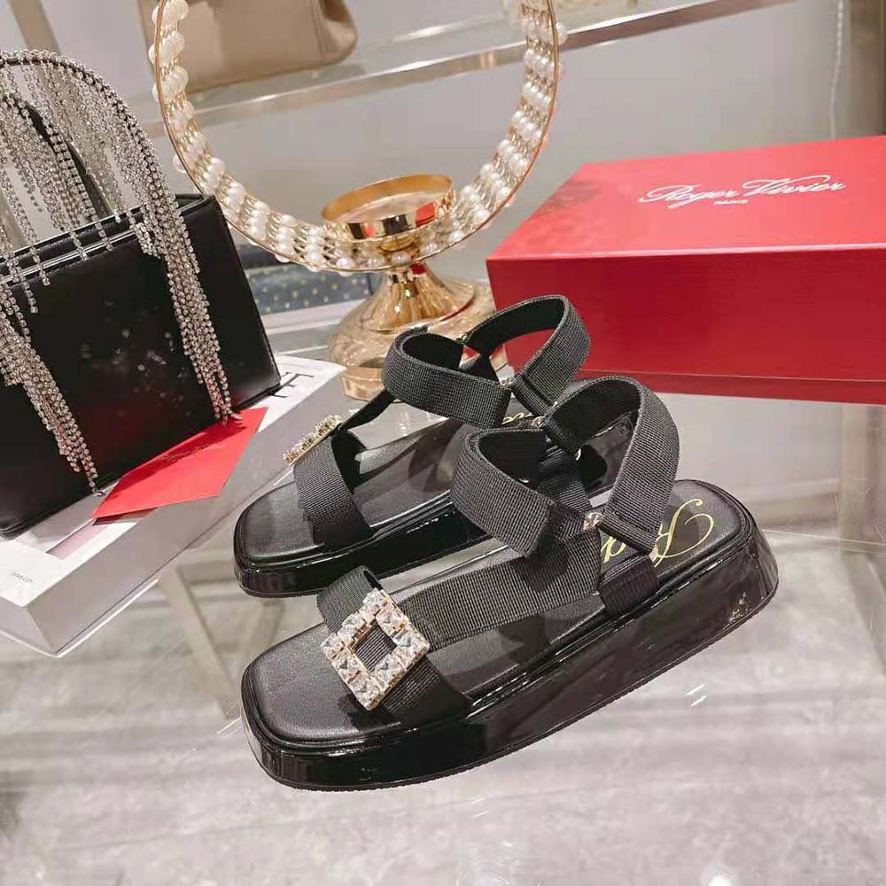 Top angle showing black fabric and flat sole of Roger Vivier slide sandals