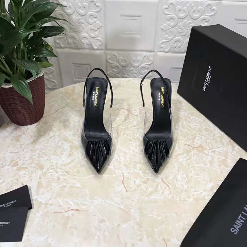 Close-up of YSL logo hardware on black slingback pumps heel