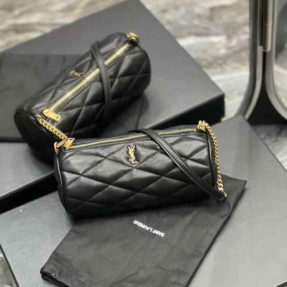 Close-up on gold YSL logo clasp of Sade Mini Tube Bag