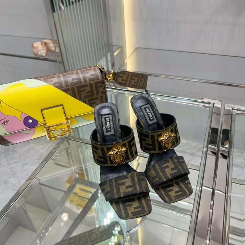 Close-up of gold FF logo hardware on Versace Women Fendace mules