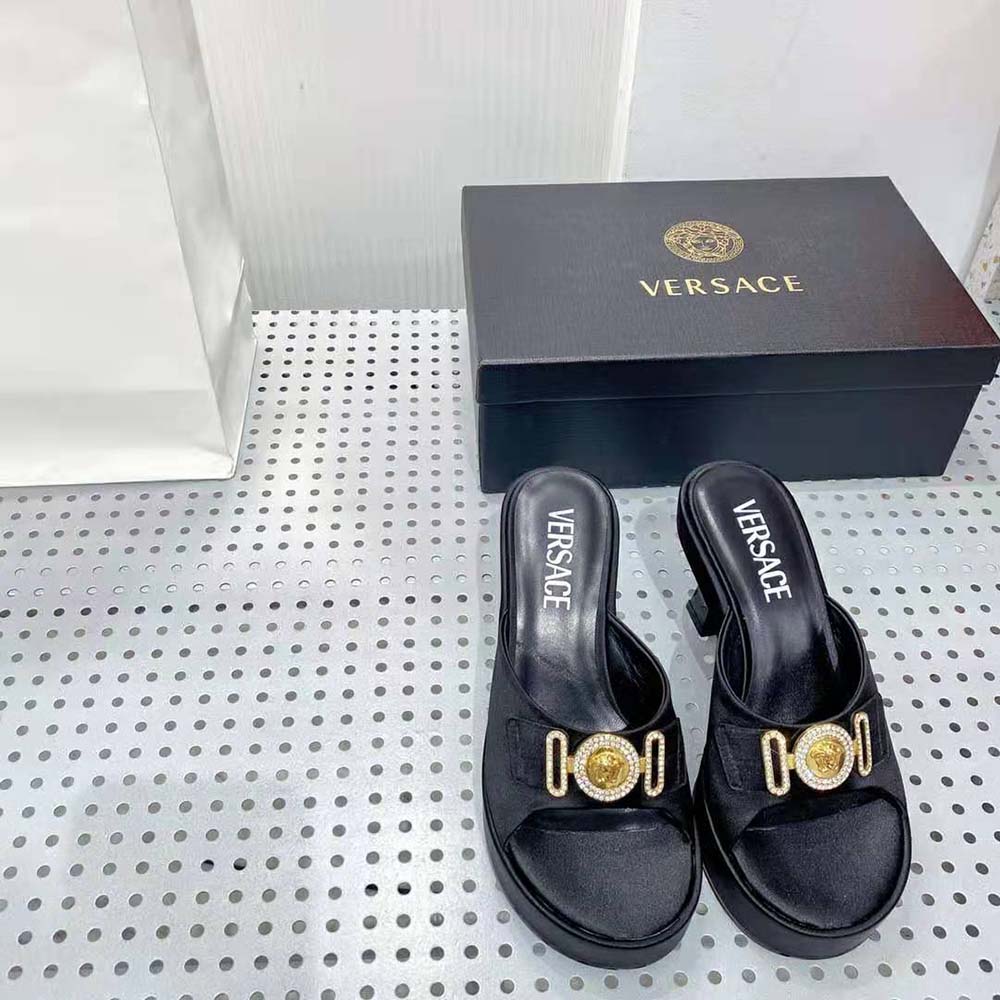 Close-up of crystal Medusa emblem on Versace Women Medusa Biggie Crystal Mules-Black