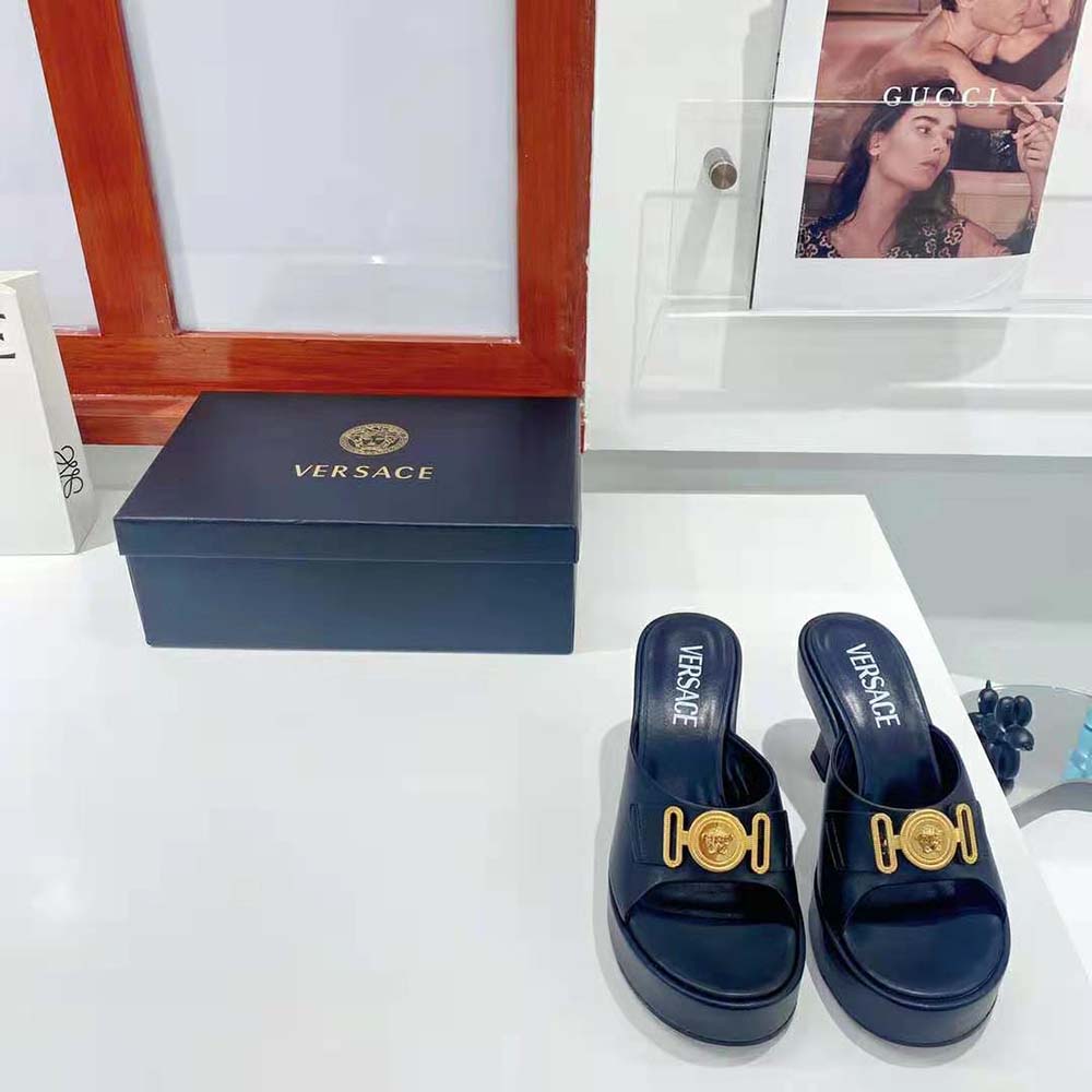Close-up of black leather and gold hardware on Versace Women Medusa Biggie Mules-Black