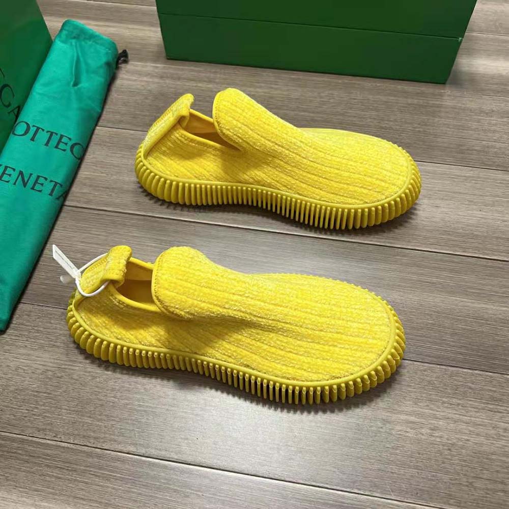 Overhead look at plush chenille texture on Bottega Veneta yellow slip-on sneakers