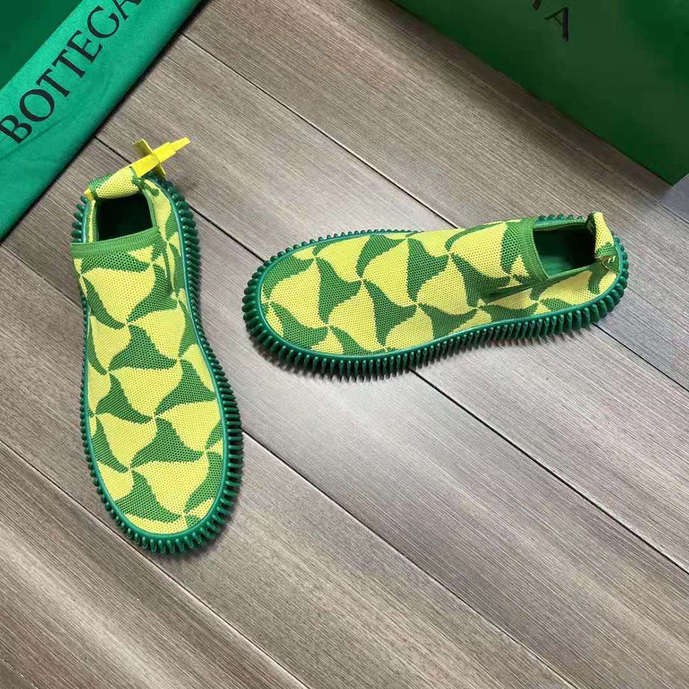 Close-up of lime tech-knit fabric and ripple triangle detail on sneakers