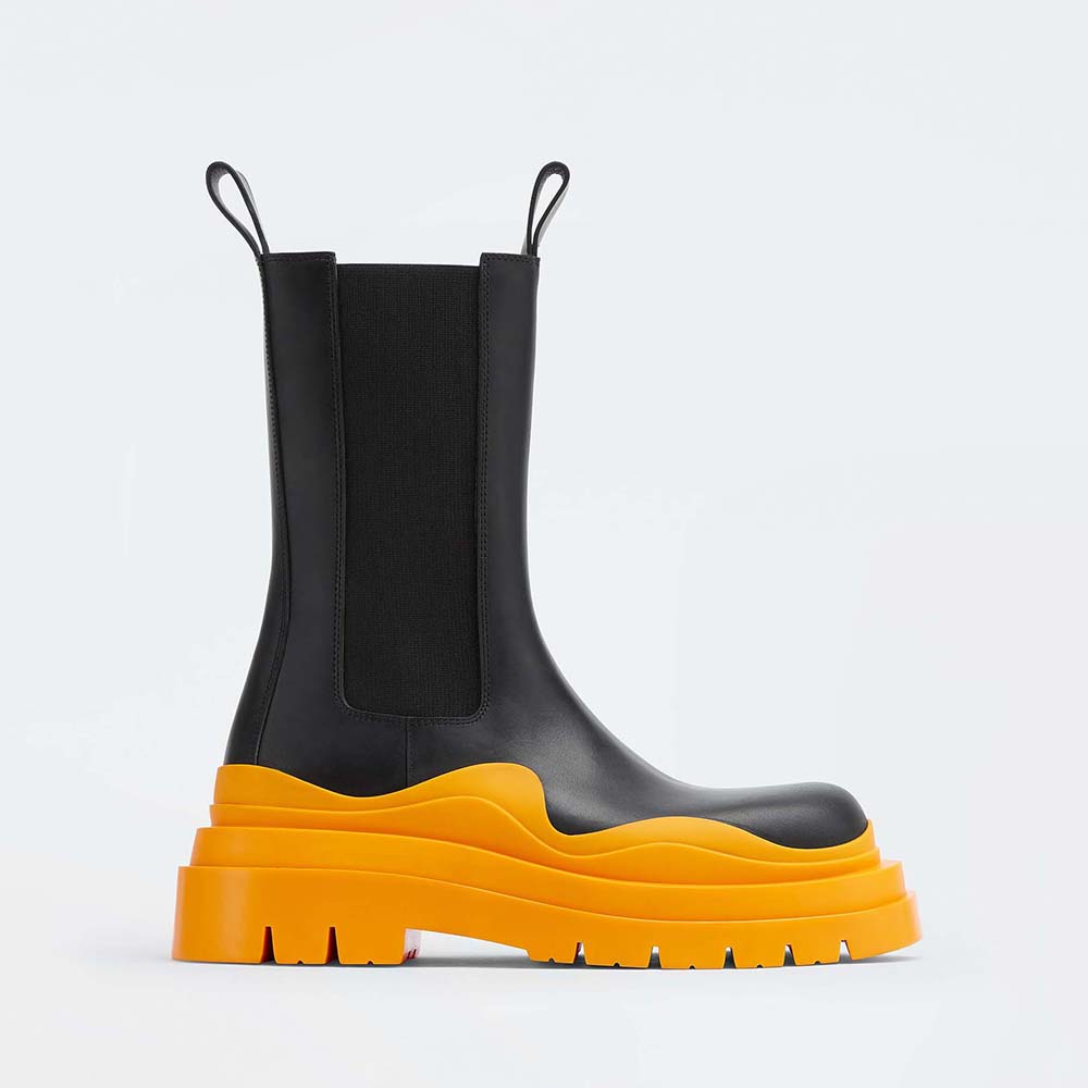 Side view of Bottega Veneta Unisex Tire Chelsea Boot in orange leather