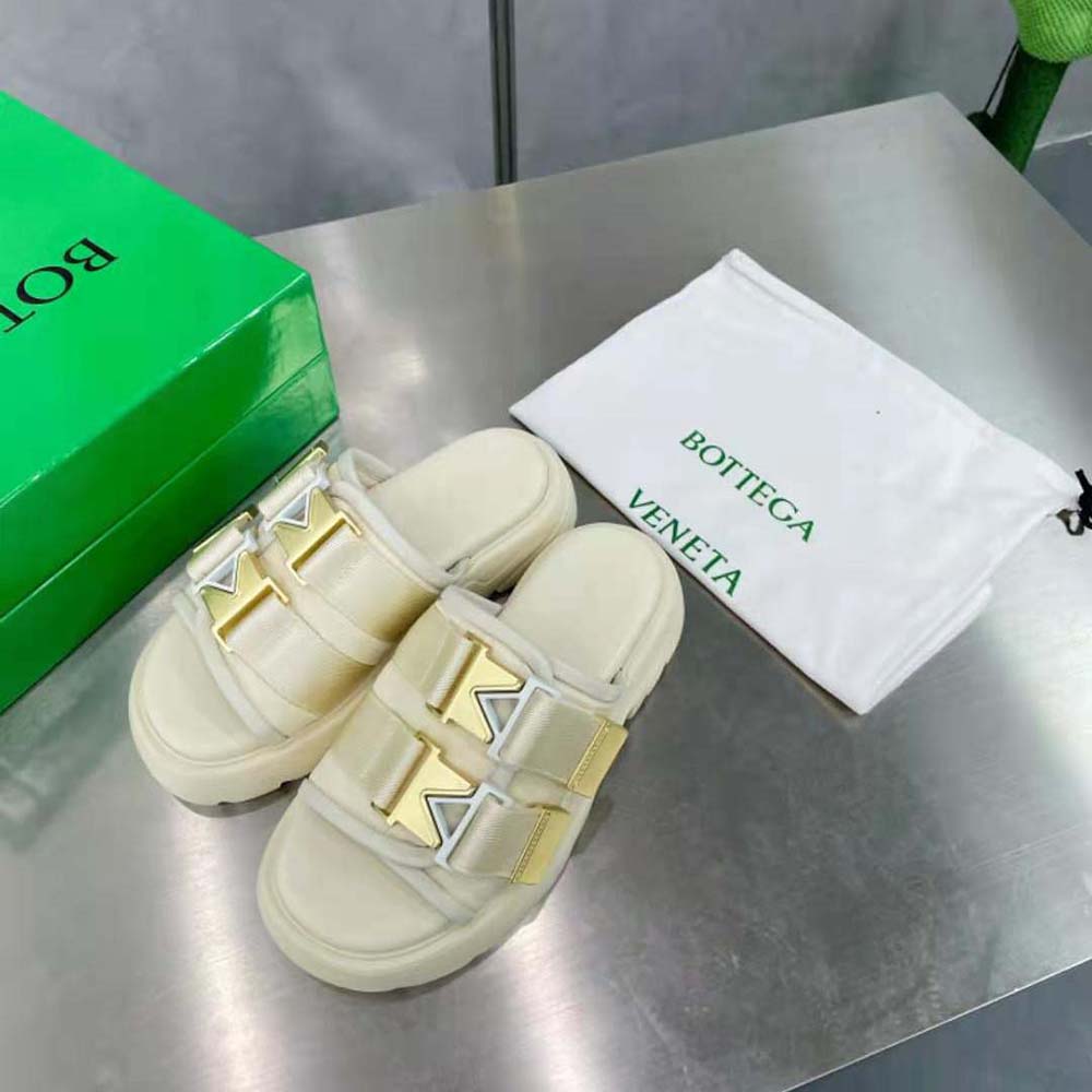 Top angle showing flat sole and cushioned technical fabric on white sandals