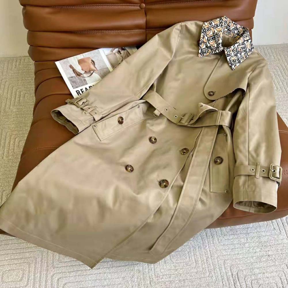 Close-up of monogram print and branded buttons on Burberry trench coat