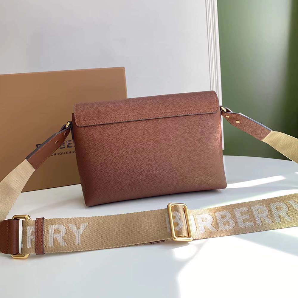 Detailed shot of gold-tone hardware on Burberry crossbody bag in brown
