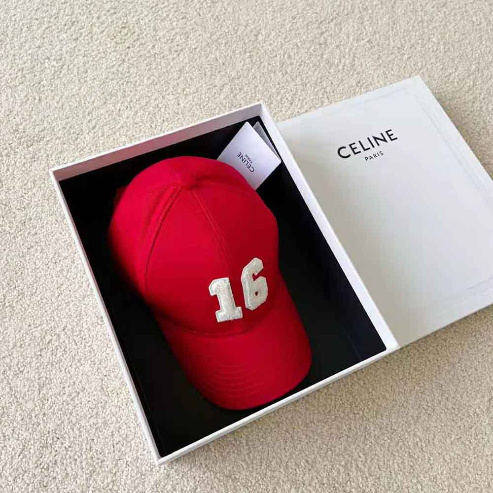 Side angle detail of red cotton fabric and curved brim on Celine cap