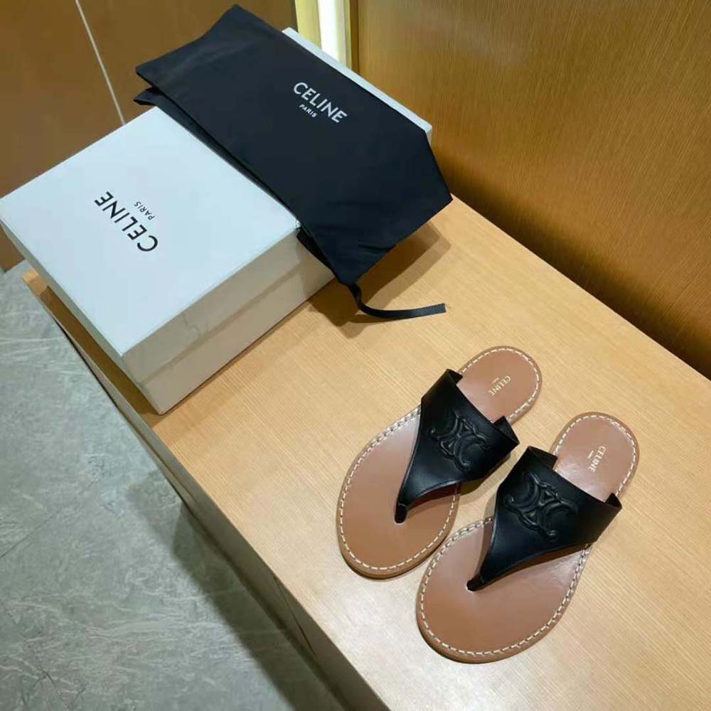 Close-up of gold Triomphe hardware on black calfskin sandal