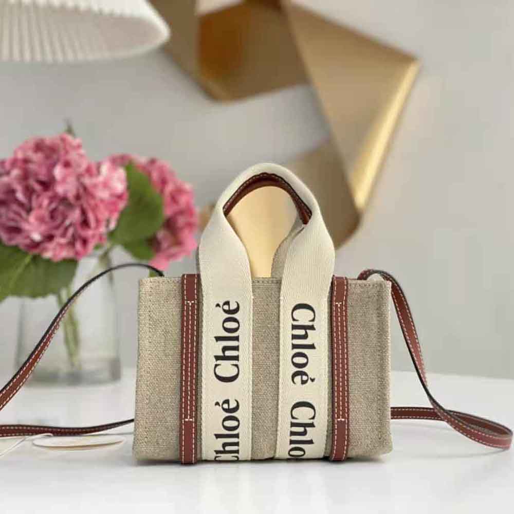 Close-up of the gold hardware on Chloe Women Mini Woody Tote Bag-Brown