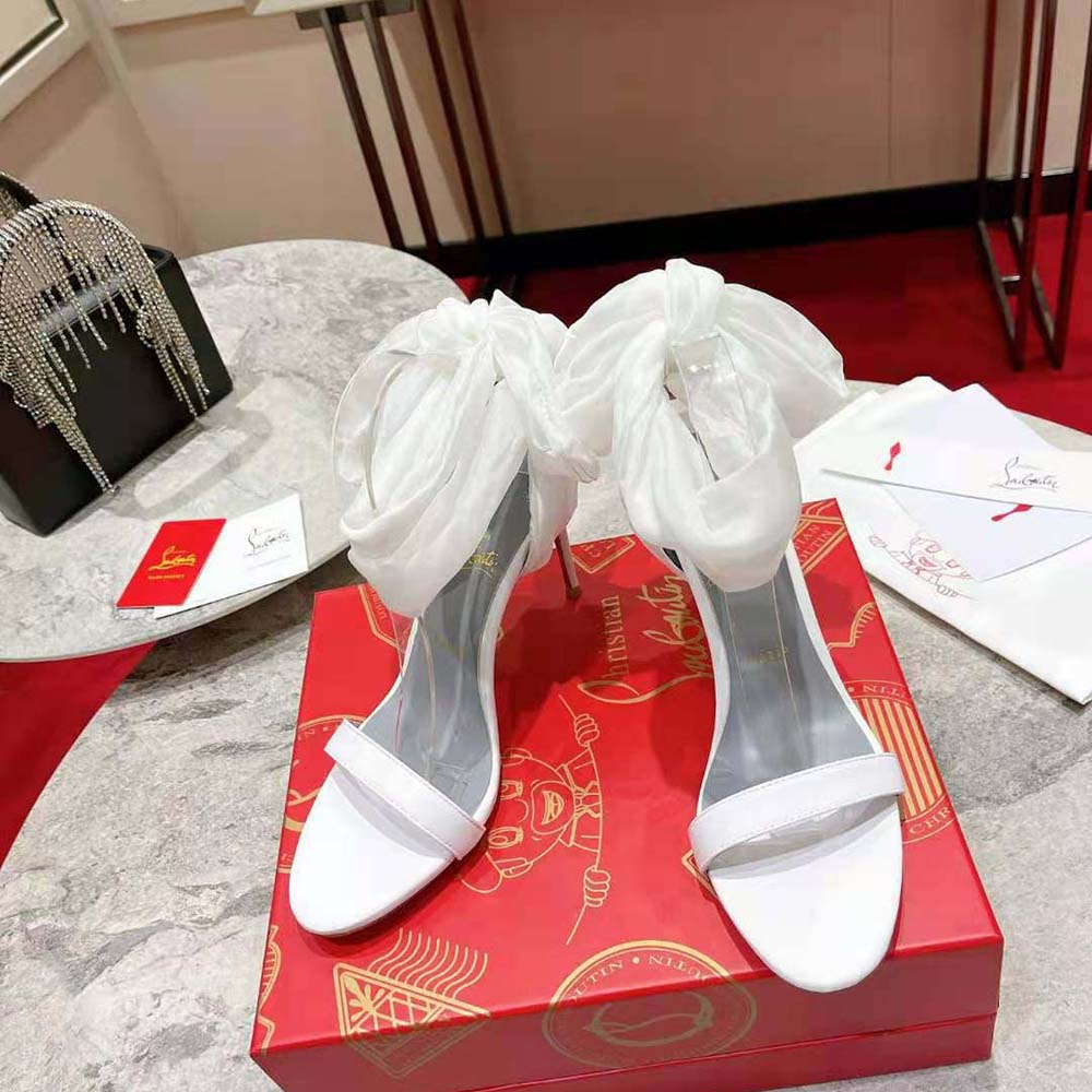 Close-up of white leather and red sole on Christian Louboutin Women Sandale Du Désert