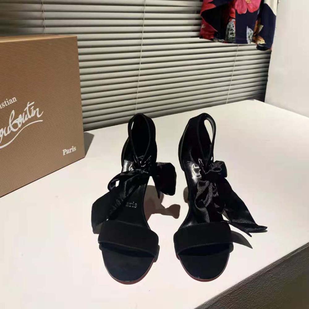 Close-up of glossy black patent leather and ankle strap on Torrida heels