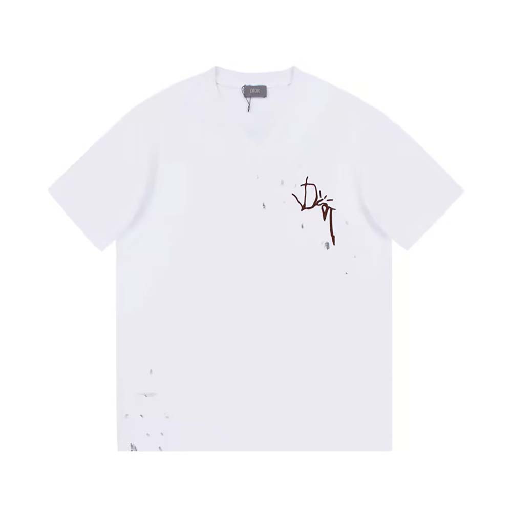 Close-up detail of Cactus Jack Dior logo on oversized white T-shirt