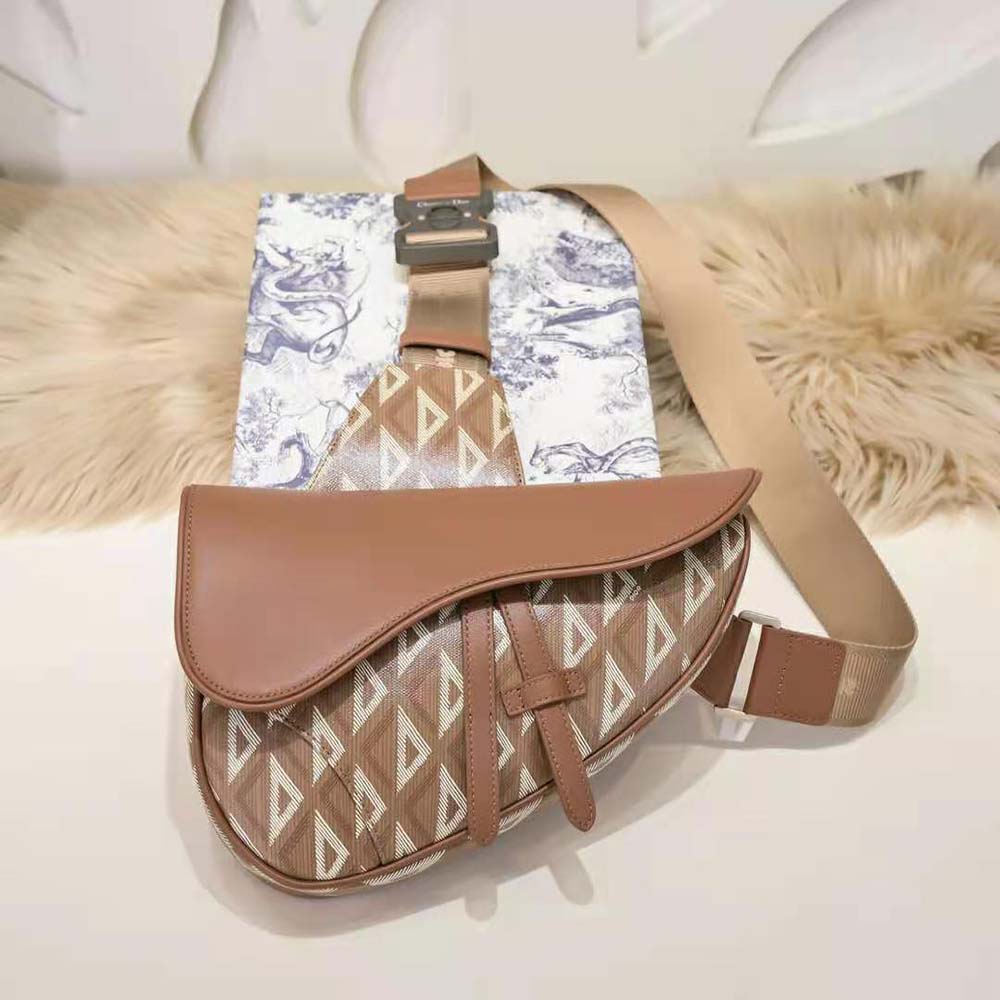 Close-up of magnetic flap and gold CD logo on Dior Men Saddle Bag