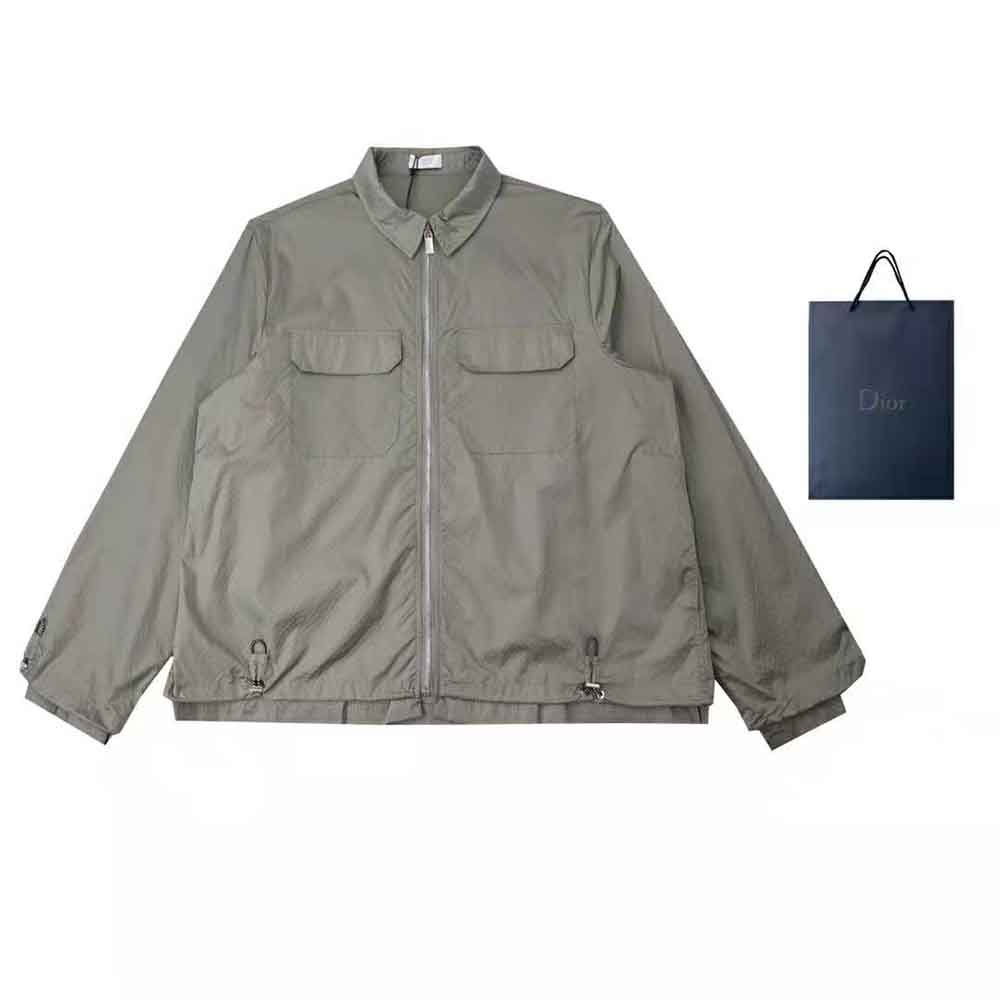 Close-up of zip and signature Dior hardware on gray blouson