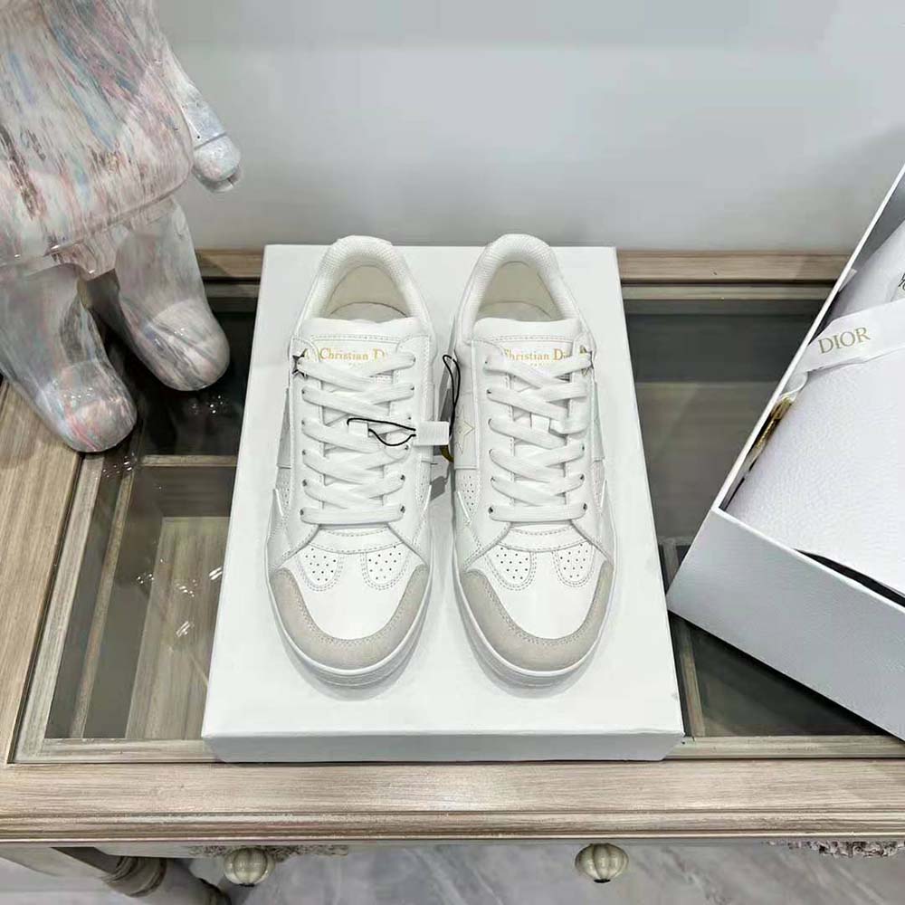 Close-up of Dior star emblem on white calfskin sneaker