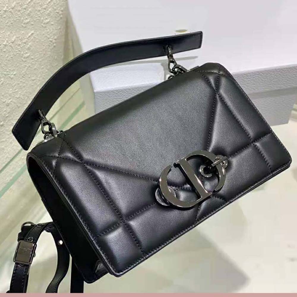 Side angle showing chain handle and flap closure on Dior bag