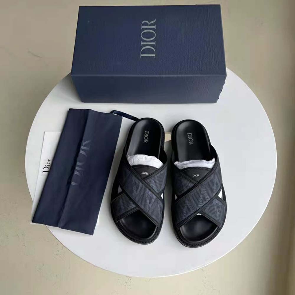 Close-up of silver CD logo hardware on Dior Men Aqua Sandal black canvas