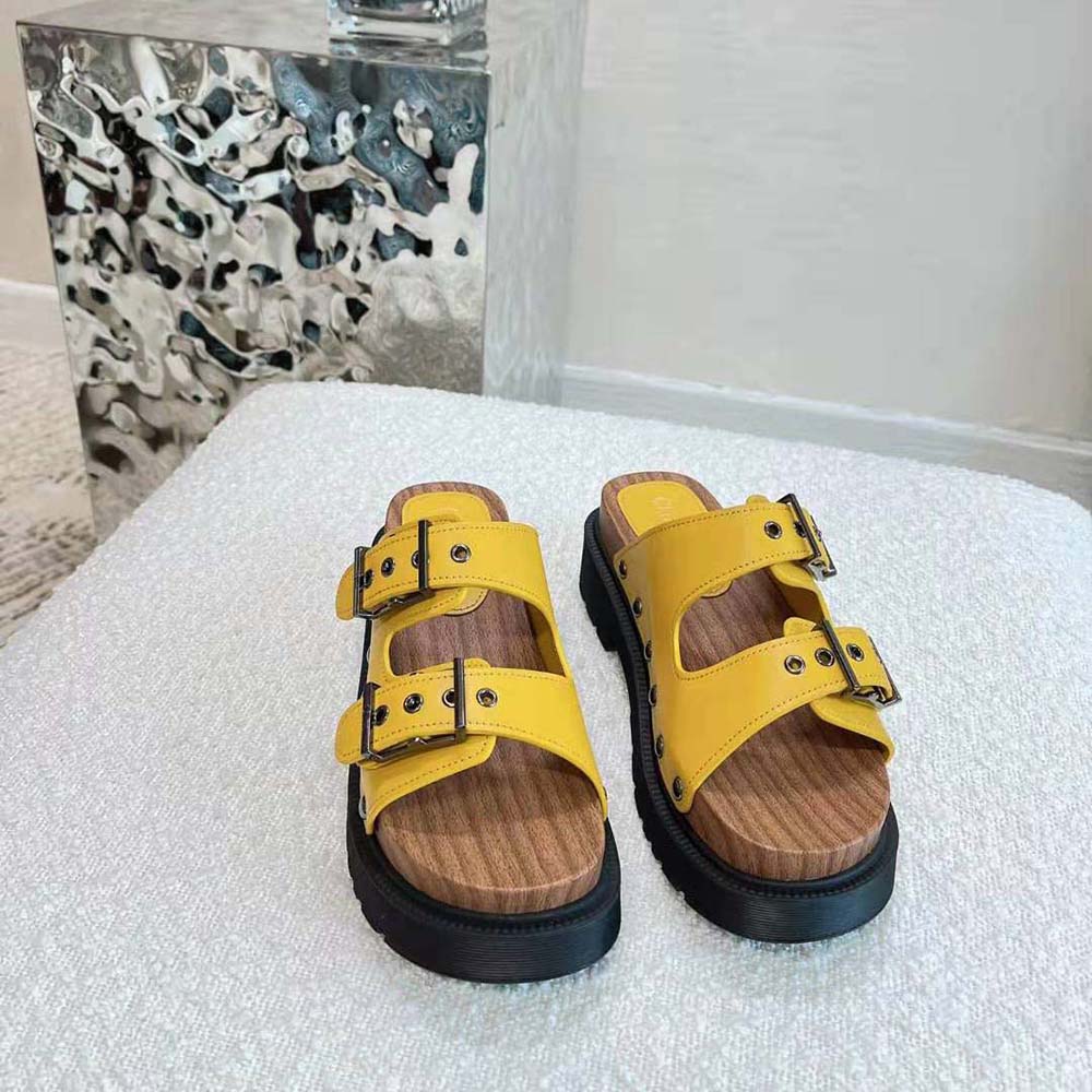 Close-up detail of silver-tone hardware on Diorquake Strap Sandal yellow leather
