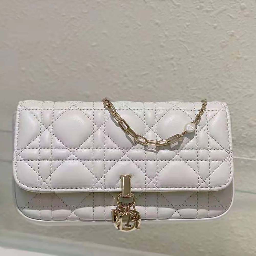 Close-up of cannage stitching and polished hardware on Lady Dior Phone Pouch