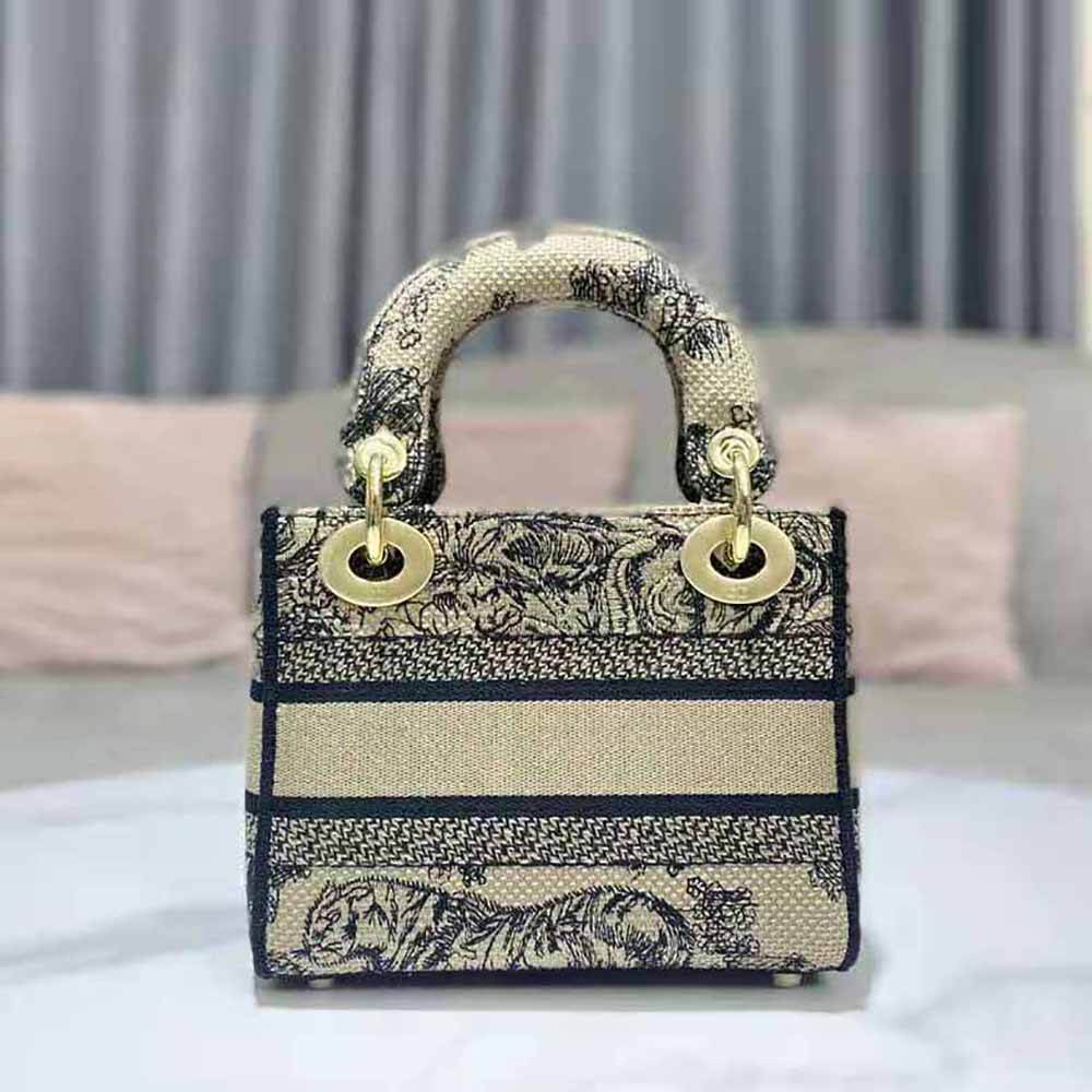 Side angle showing gold hardware and silhouette of Dior Women Mini Lady D-lite Bag