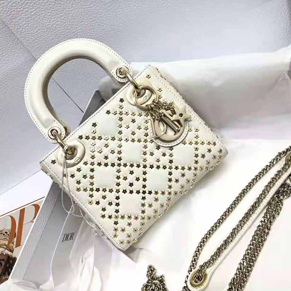 Close-up of white lambskin and Lucky Star charm detail on Lady Dior bag