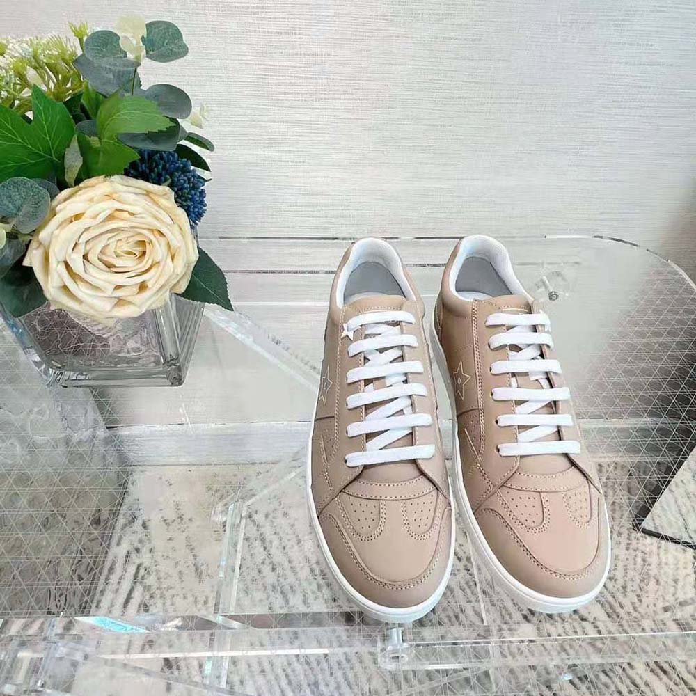 Close-up on silver star hardware of Dior Women Star Sneaker Nude Calfskin