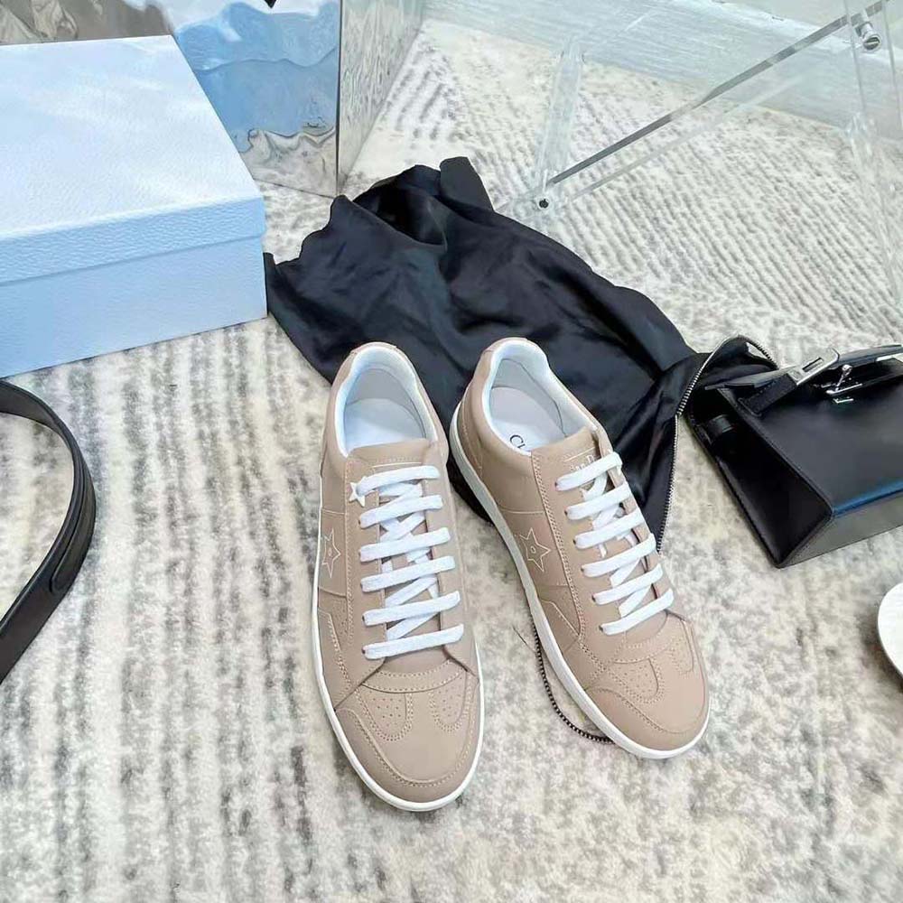 Top angle showing laces and calfskin texture of Dior Women Star Sneaker Nude Calfskin