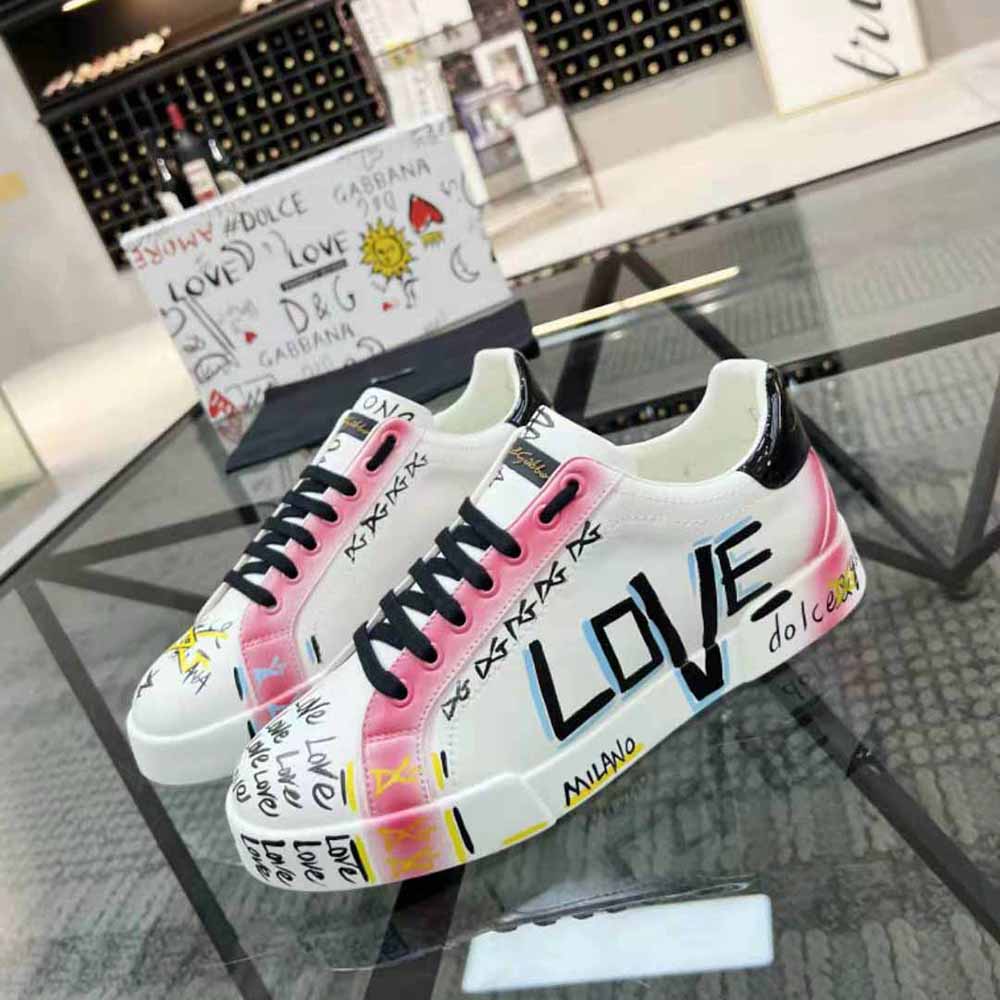 Close-up on lace-up closure and D&G logo hardware of Portofino Sneakers