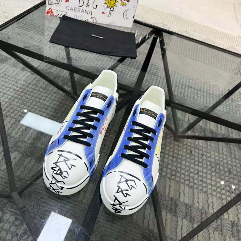 Close-up on signature D&G hardware detail on blue Portofino sneakers