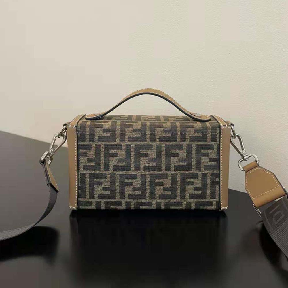 Side view highlighting silhouette of Fendi Men Baguette Soft Trunk Brown FF Fabric Bag