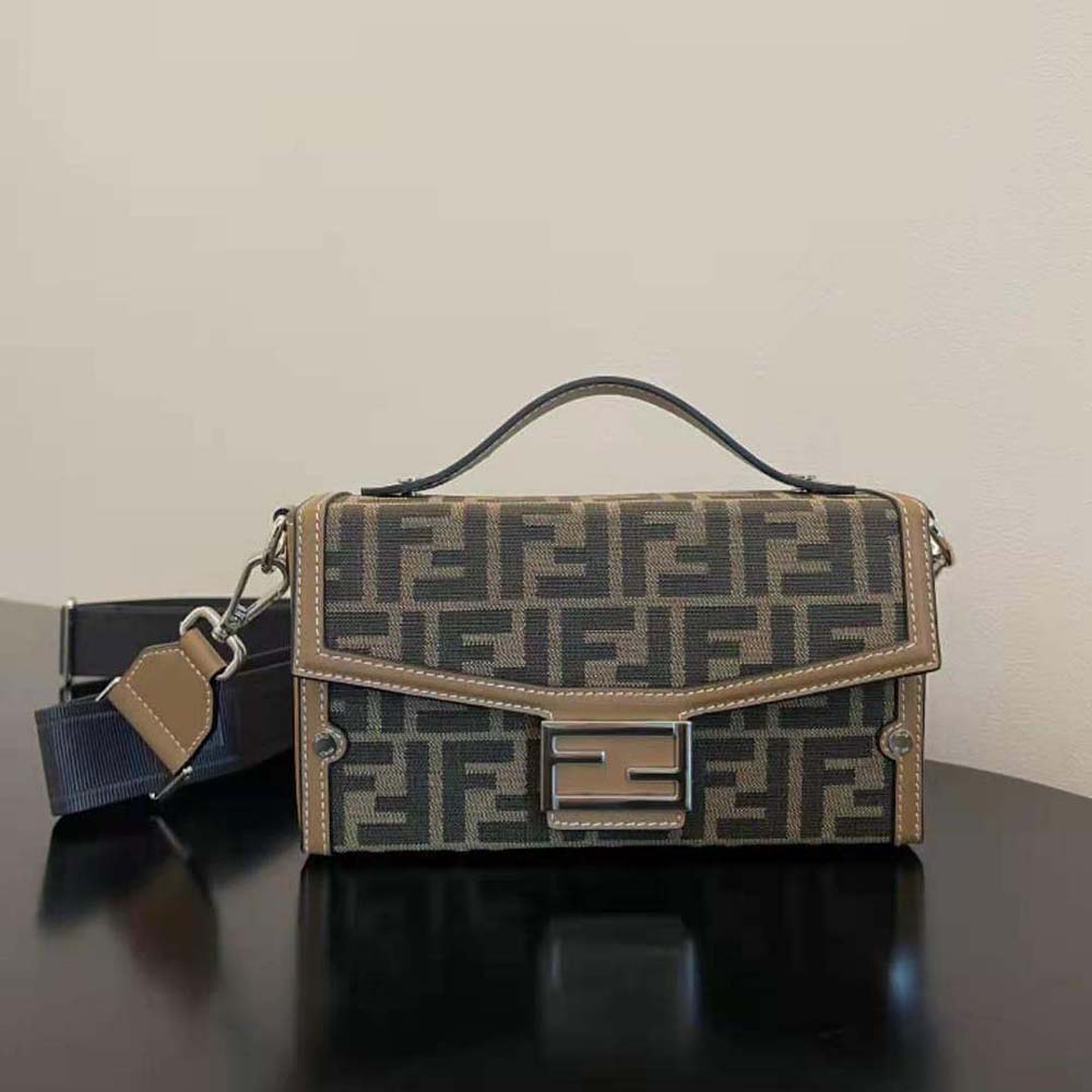 Close-up of gold-tone hardware on Fendi Men Baguette Soft Trunk Brown FF Fabric Bag