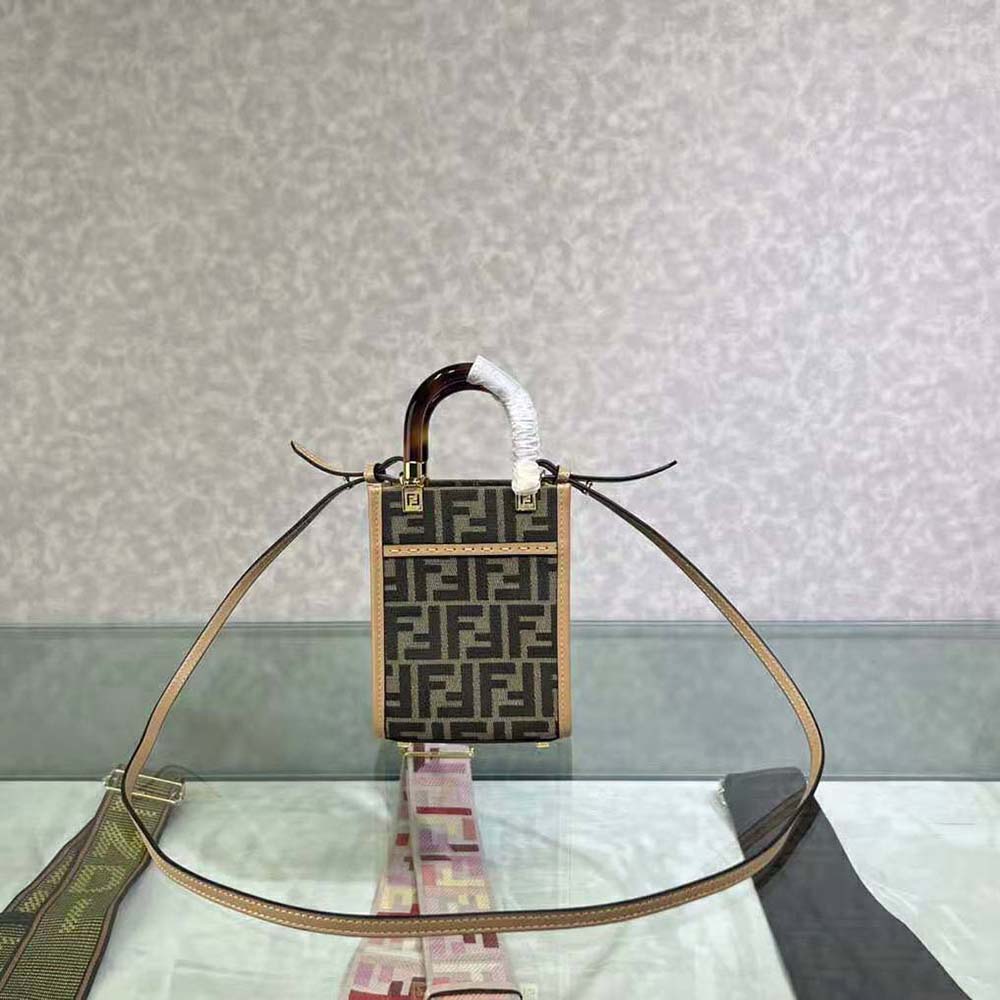 Close-up on gold hardware and brown FF fabric detail of Fendi mini-bag