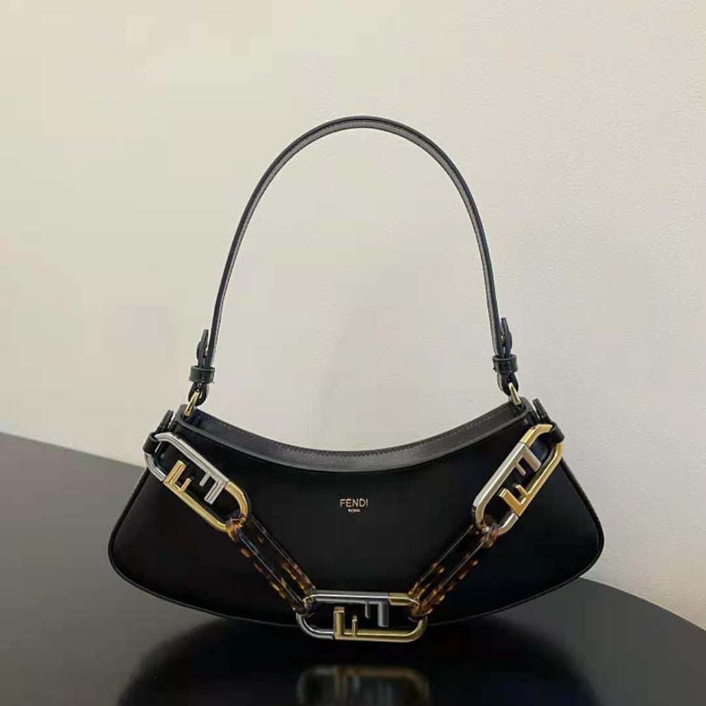 Close-up of Fendi O’Lock gold hardware on black leather pouch