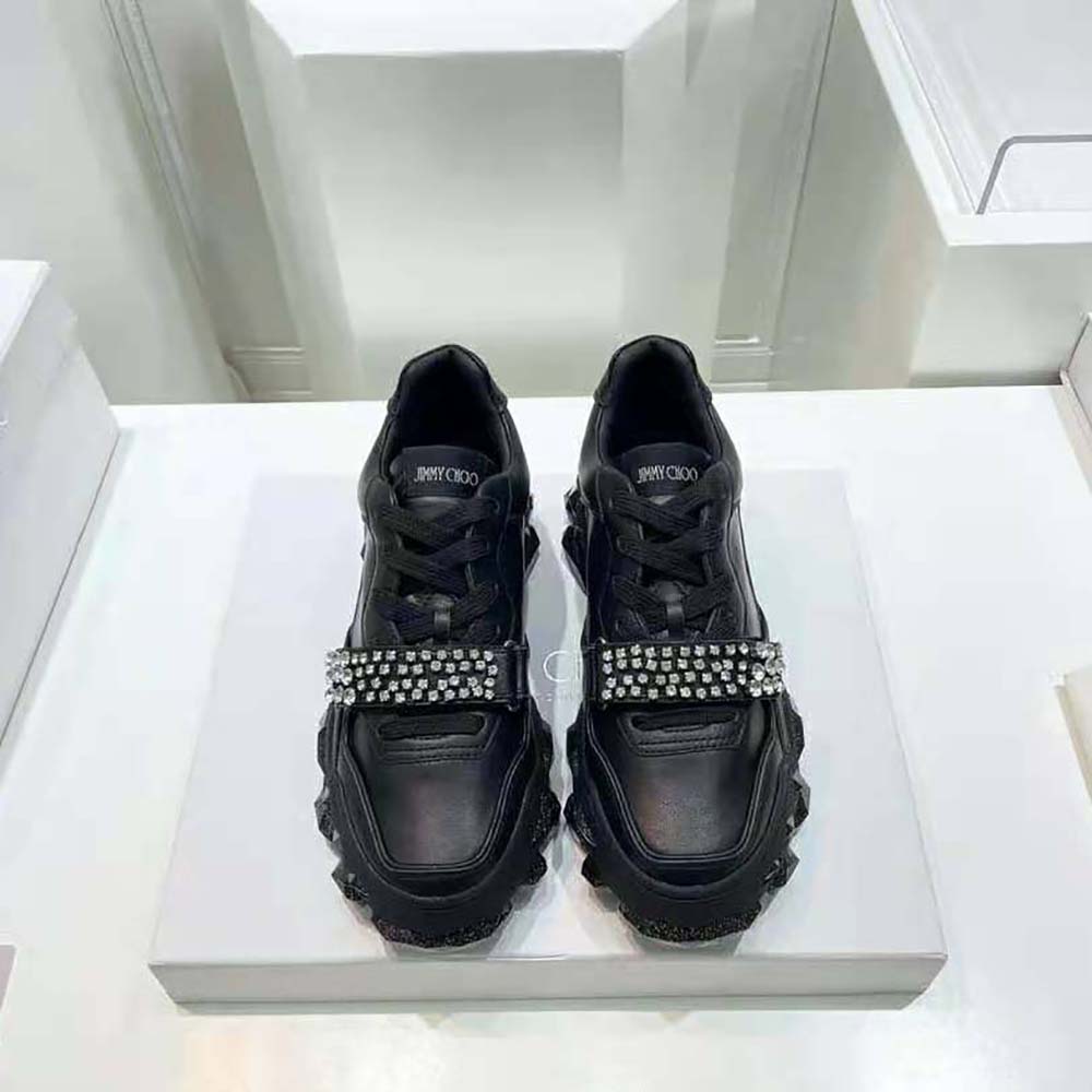 Close-up of crystal X strap detail on Jimmy Choo Black Calf Leather Trainers