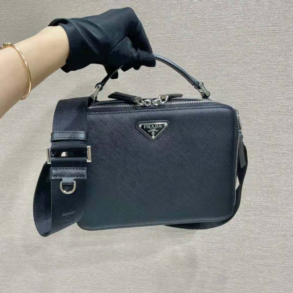 Close-up on silver-tone hardware and saffiano leather texture of Prada bag