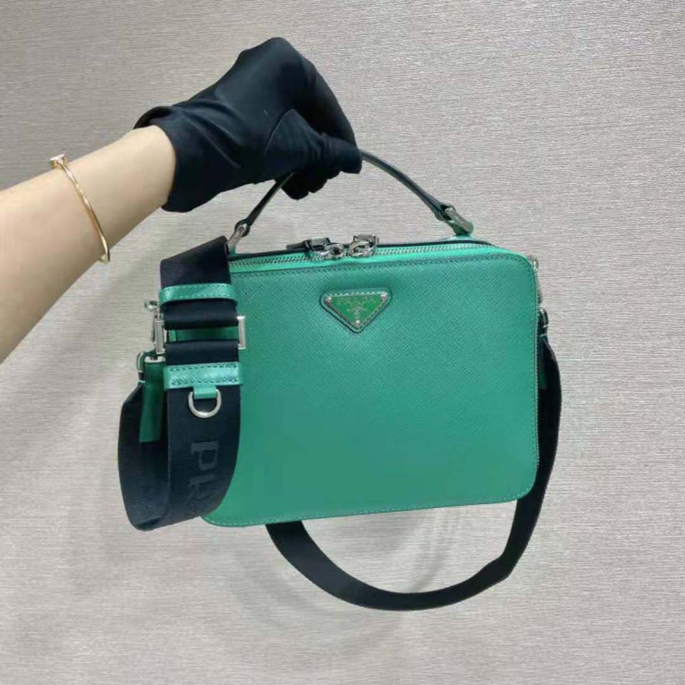 Close-up of green Saffiano leather texture on Prada Men Brique bag