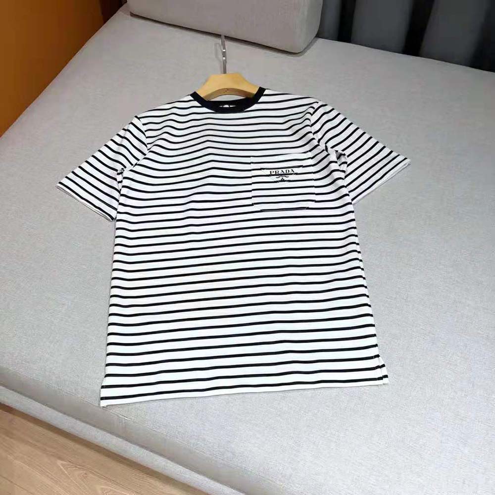 Close-up on overprinted Prada logo detail on black cotton T-shirt