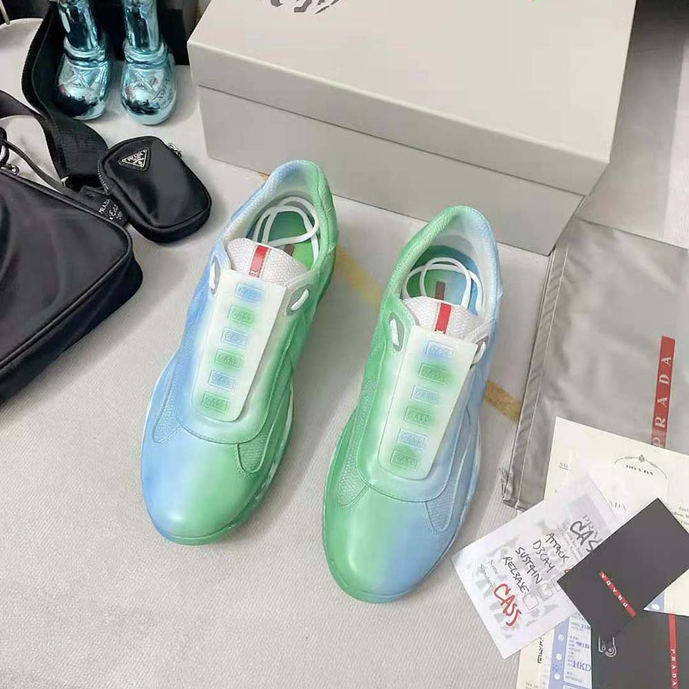 Close-up of blue technical mesh and Prada logo on sneakers